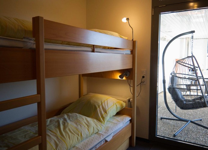Schlafzimmer mit Etagenbett und Durchgang auf die Terrasse in der Inselblume 82