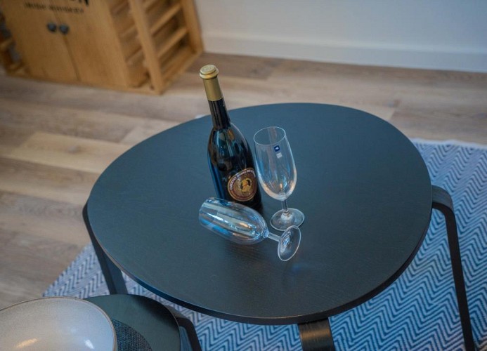 Wohnzimmertisch mit einer Flasche Wein in der Fewo
