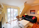 Wohnzimmer mit Couch und Balkon in der Ferienwohnung für 8 Personen in Burg auf Fehmarn